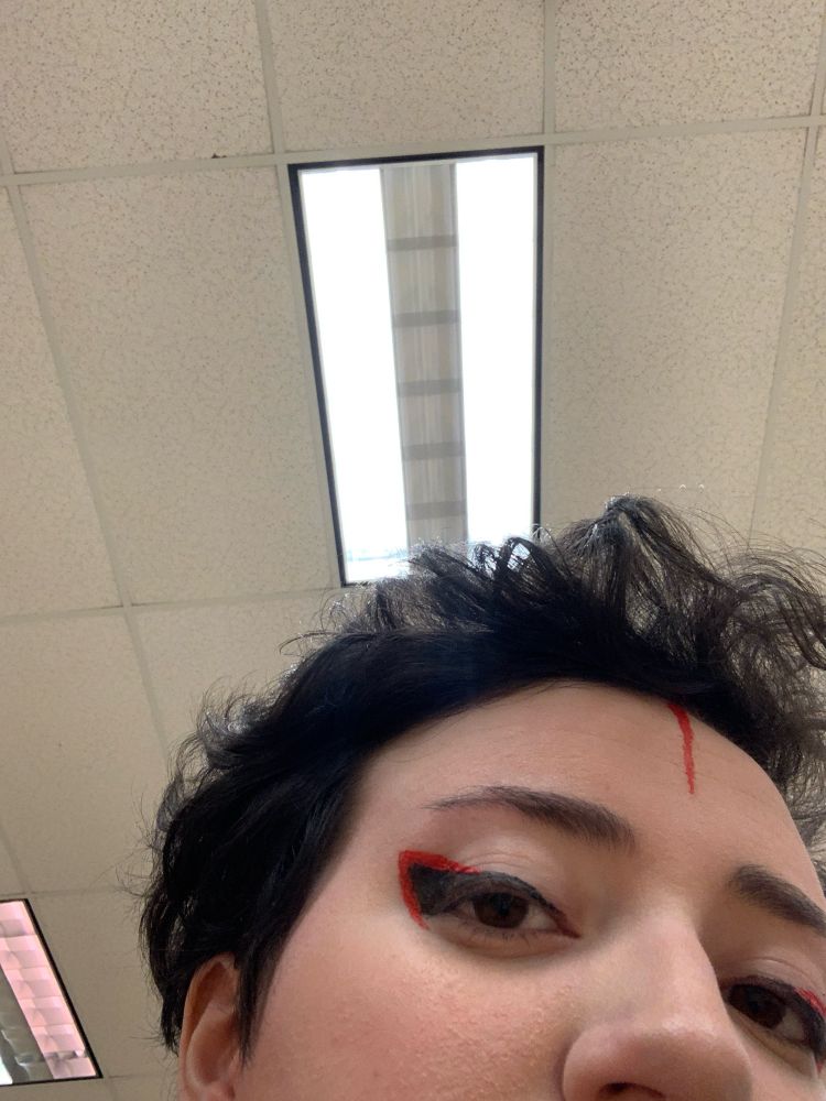 Shadow the hedgehog inspired eyeliner, with a thick black line around the eye followed by a red arrowhead shape even farther out.