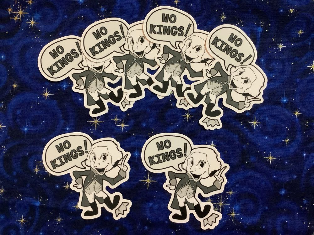 A small collection of 6 identical stickers against a starry fabric background.  The sticker graphic is a cartoon George Washington saying “No Kings!”