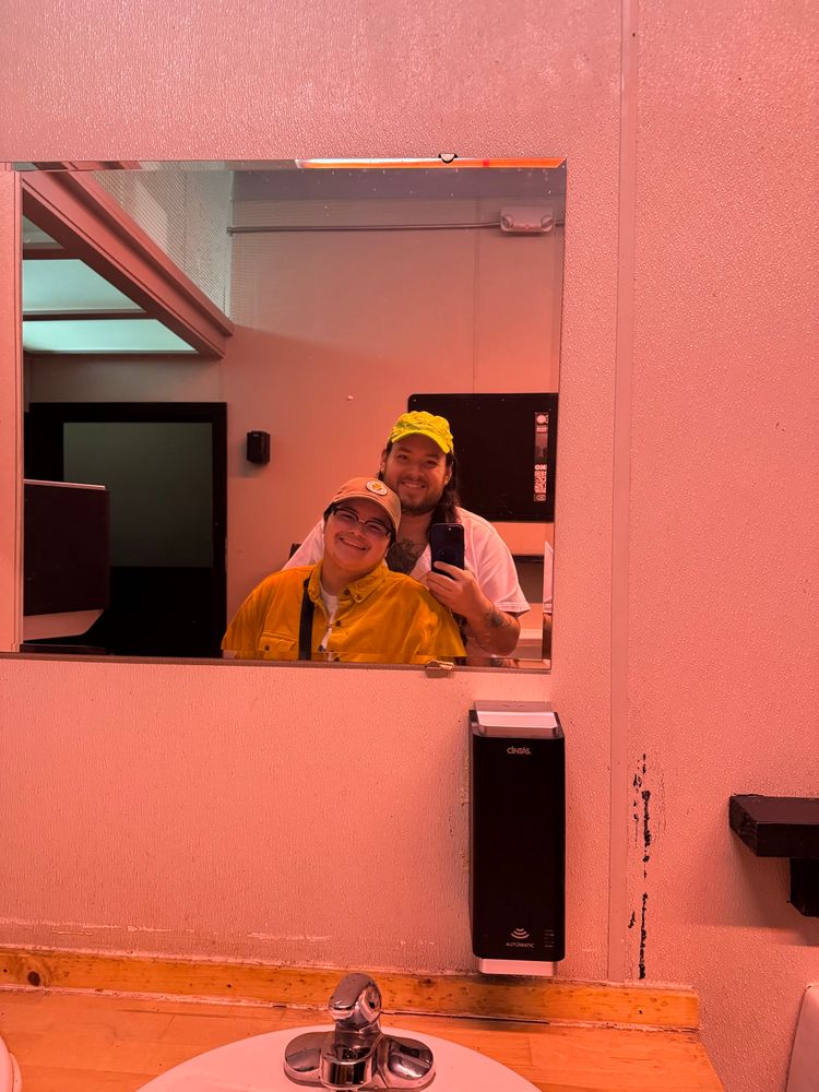 Elijah and Ty in a bathroom mirror inside The Cuff 