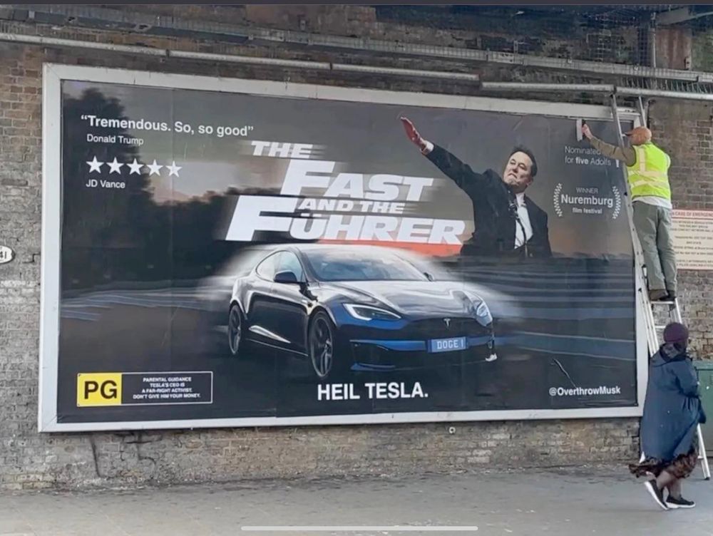Billboard posted in London showing Elon Musk's salute as if on a Fast and the Furious poster, renamed "The Fast and the Fuhrer" with some other creative notes scattered.