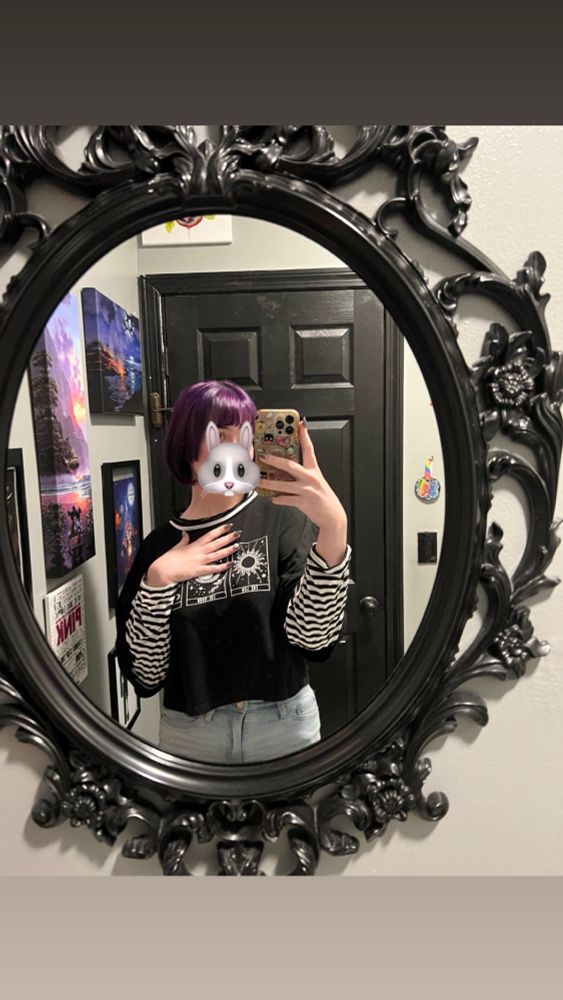 a mirror selfie of bunni they have a dark purple, short hime cut 