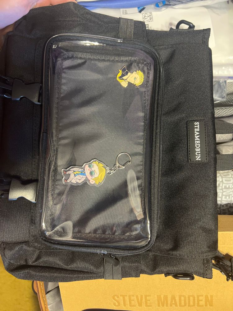 a picture of bunni’s ita bag backpack with their nanami enamel pic and the nanami keychain 