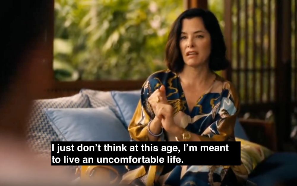 Parker Posey in The White Lotus Season 3, rubbing lotion on her hands while frowning in an expensive caftan saying "I just don't think at this age, I'm meant to live an uncomfortable life."