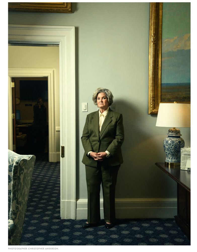 Photo of Susie Wiles, an older woman in a green suit with her hands clasped in front of her standing next to a doorway in the white house where she is the chief of staff. Photo by photographer Christopher Anderson for Vanity Fair. 