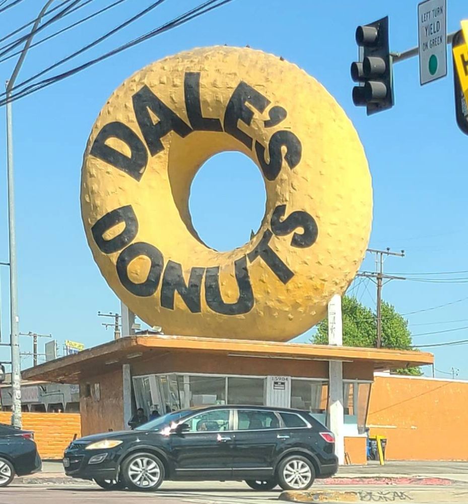 a photo of a giant donut with the text Dale's Donuts on top of a small corner donut shop near Compton, CA