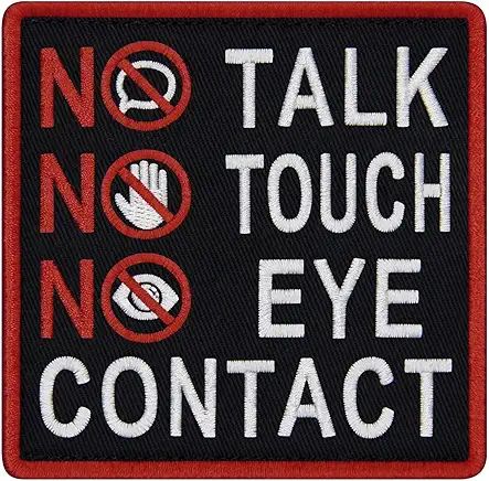 a patch that reads 
NO TALK
NO TOUCH
NO EYE CONTACT