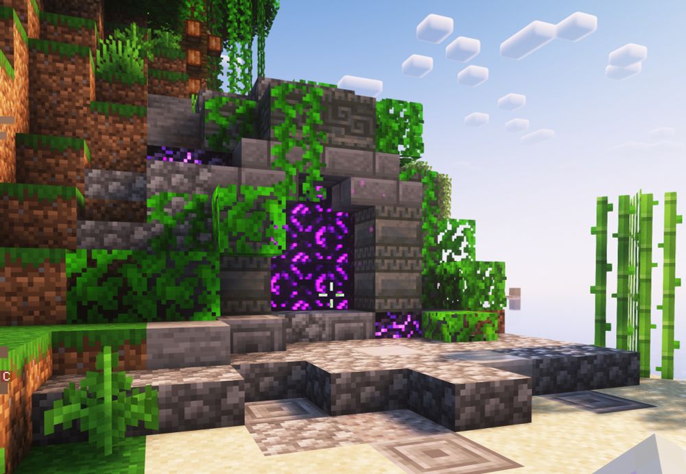 A screenshot of a decorated Nether Portal in Minecraft. It is built into the side of a hill on a beach and is surrounded by stone, leaves, and vines. 