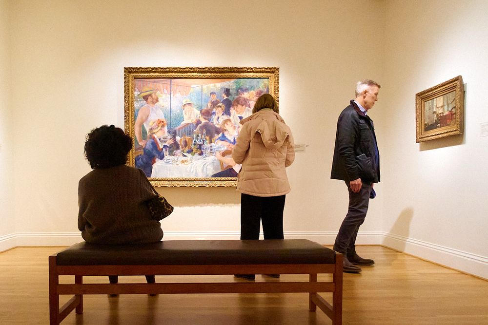 Art enjoyers (including myself) are transfixed by Renoir’s masterpiece “Luncheon of the Boating Party”. Another person is viewing Edouard Vuillard’s “The Newspaper”. 