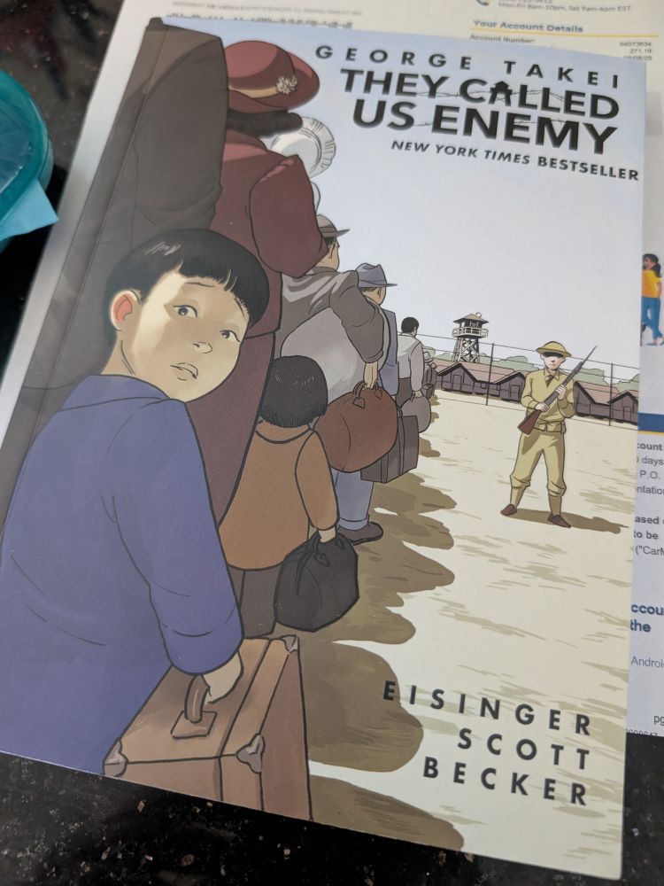 Photo of a book by George Takei and Eisinger Scott Becker 'They Called us Enemy' on the counter. 