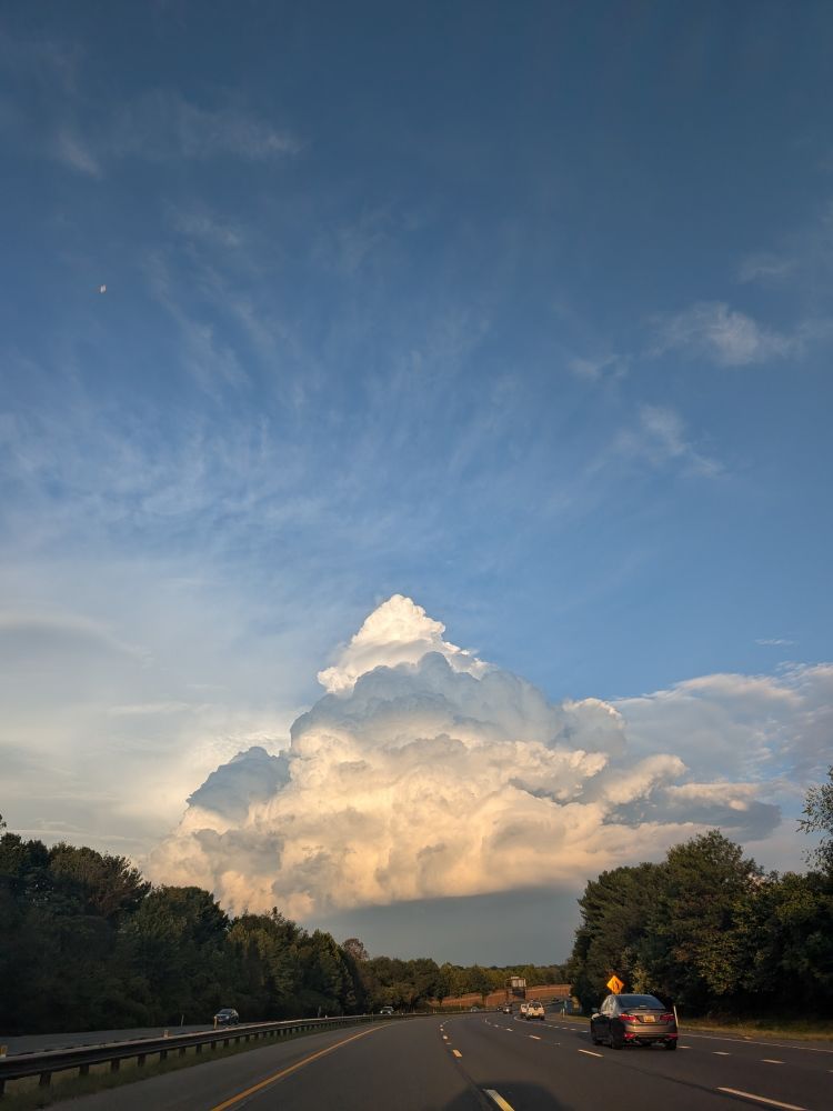 pretty sky, with a cloud that looks like a mountain in a distance