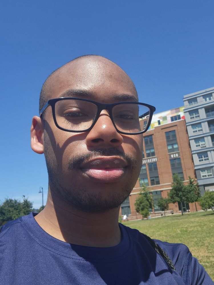 Albert outside at a park sunkissed after an outdoor yoga session with slightly different angle.