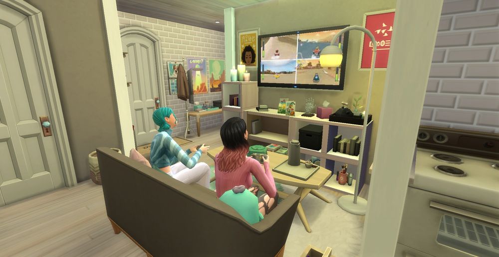 Screenshot of the Sims 4. Living room with two sims playing video games.