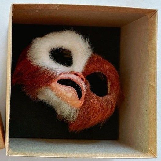 a faceplate for an animatronic of the character Gizmo from the film Gremlins, in a pained expression