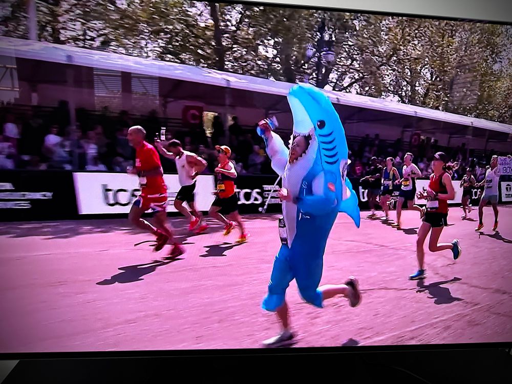 A man in a shark outfit running the London Marathon
