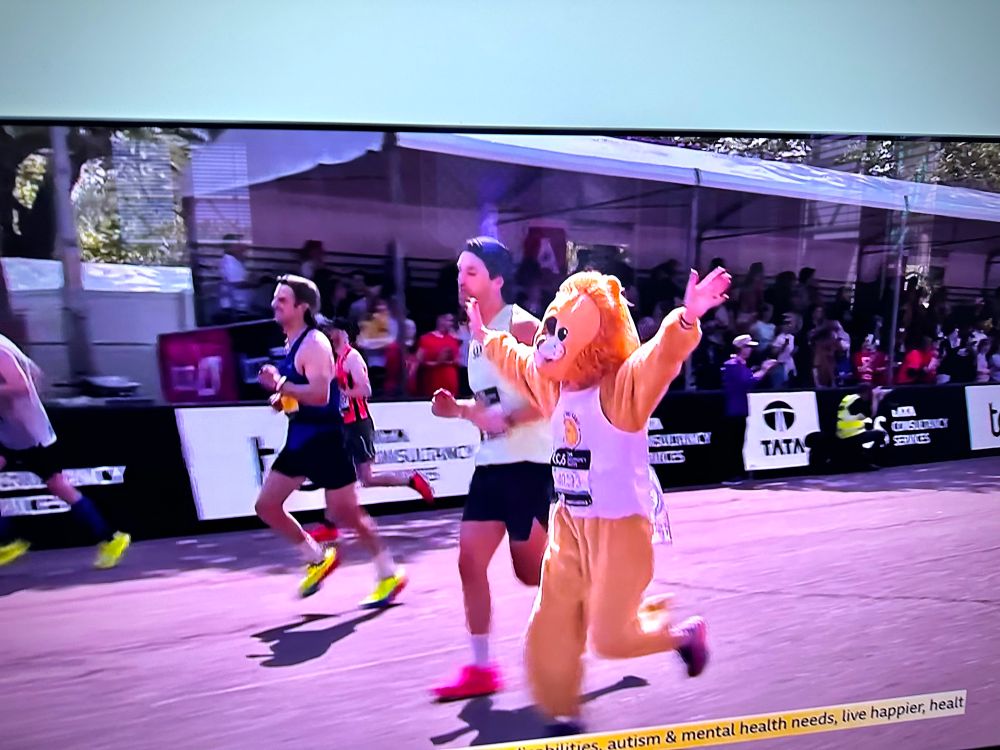 A man in a lion outfit running the London Marathon