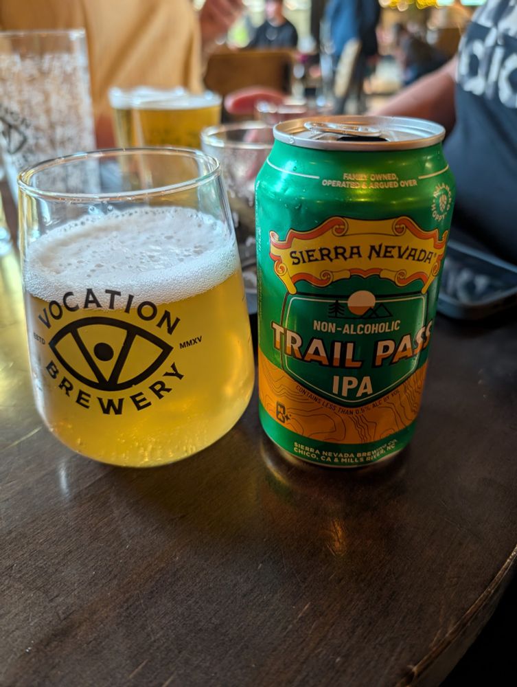 Trail Pass IPA can of beer poured into a glass