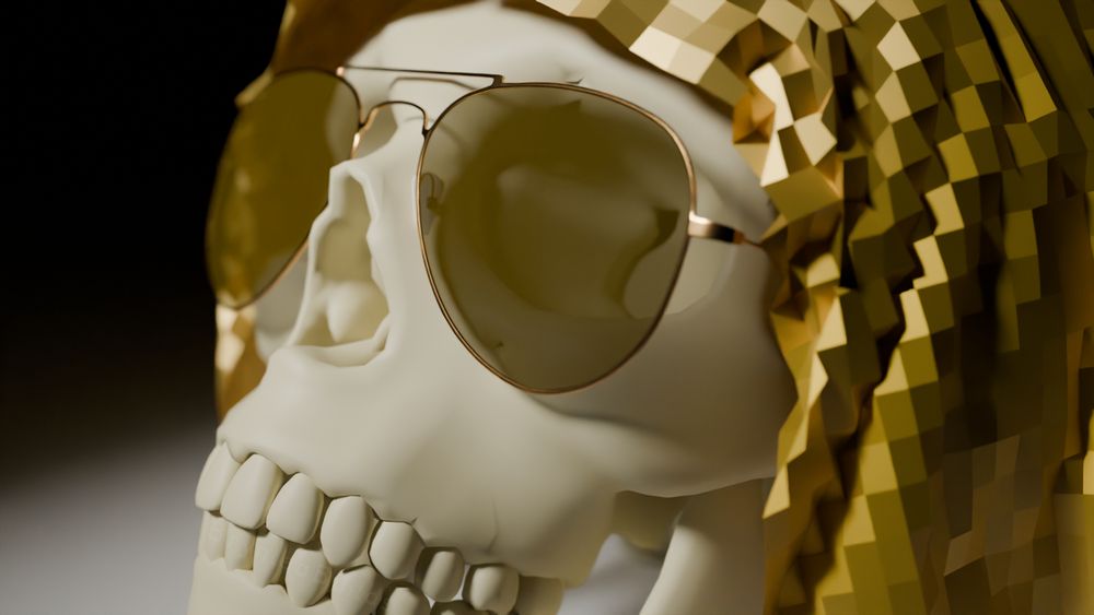 Close-up of a skull, facing up and out towards a spotlight, dressed in a gold veil and aviator sunglasses.
