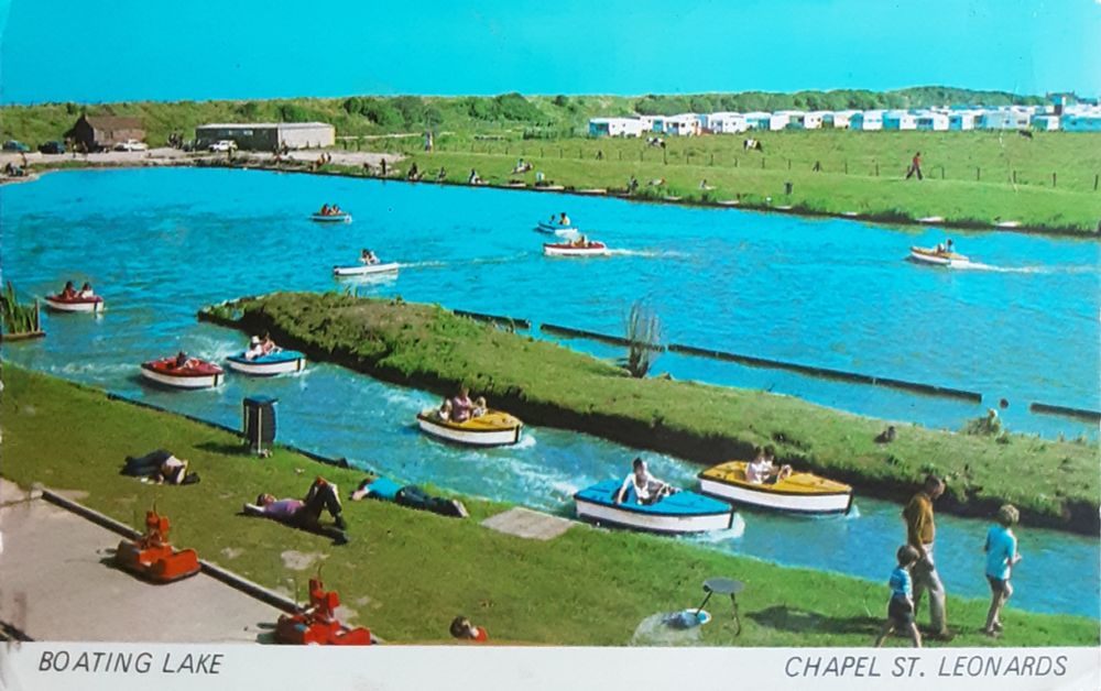 Sapphire card of the boating lake at Chapel St Leonards with caravan park in the distance
