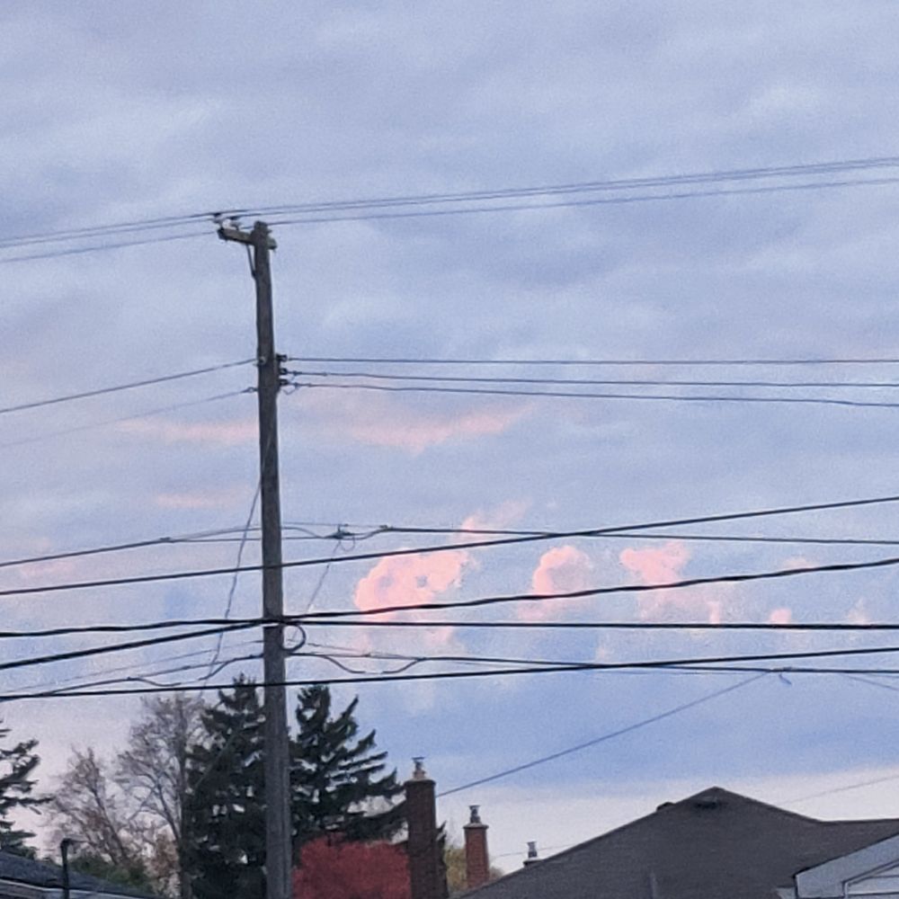 A sunset obscured by big electric power lines