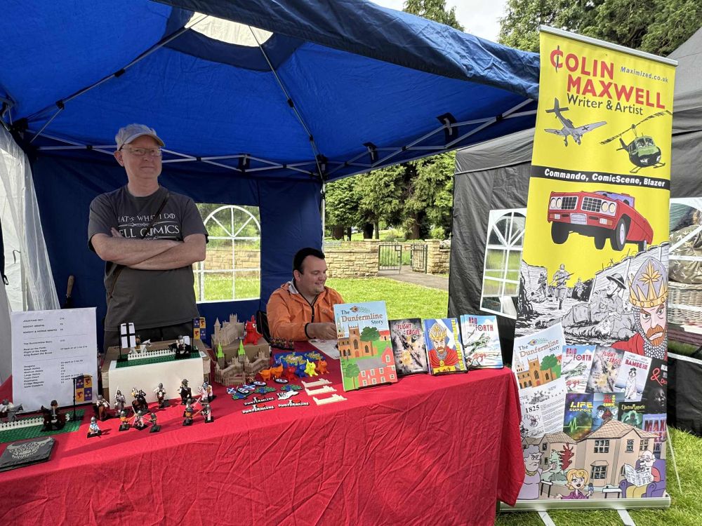 Colin and Calum Maxwell at their stall at the Bruce Festival, Dunfermline, selling comics and crafts. 31 May 2025.