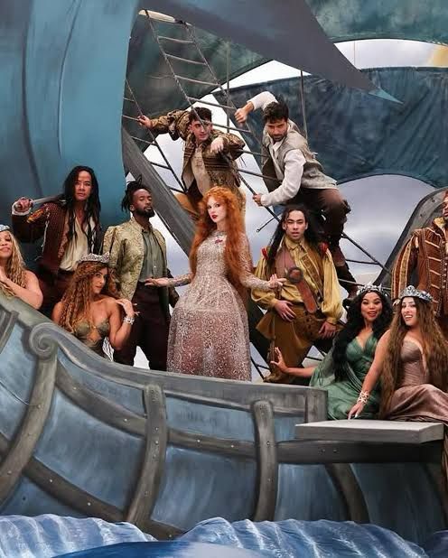 taylor swift and her eras tour dancers on a theatrical staged wooden boat 
