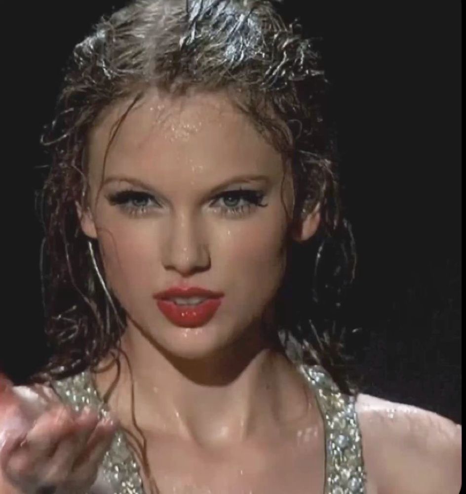taylor swift on stage at the fearless tour wet from the rain 