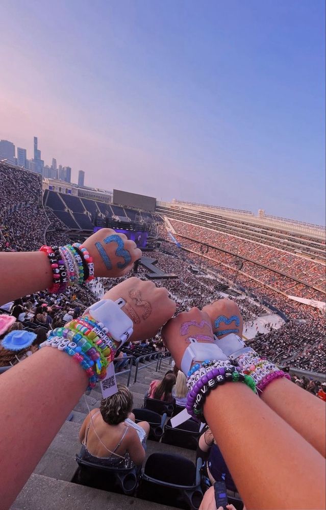 Swifties with 13s on their hands and friendship bracelets attending the eras tour