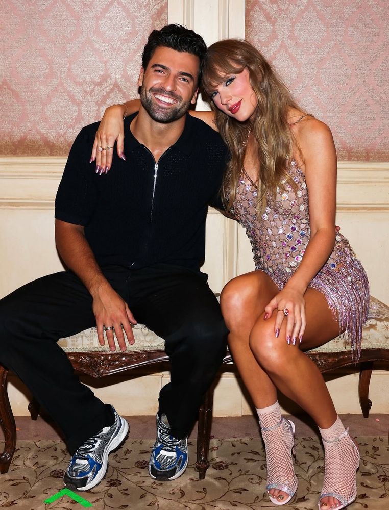 taylor swift and jan ravnik, sitting and posing for a picture together 