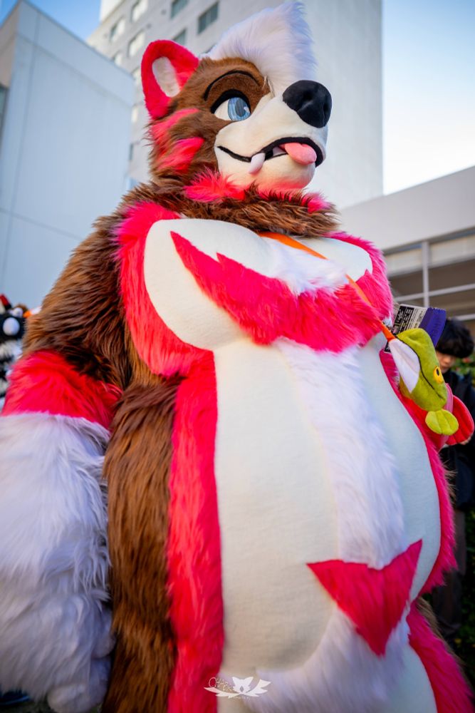 Neapolitan coloured bear fursuit, extra chonky, eats too much ice cream, claims to be tall but is actually average height.