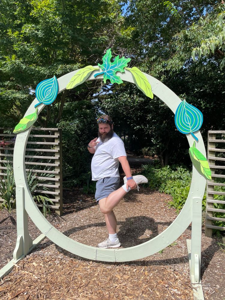 A picture of me holding my foot up in a circle of leaves
