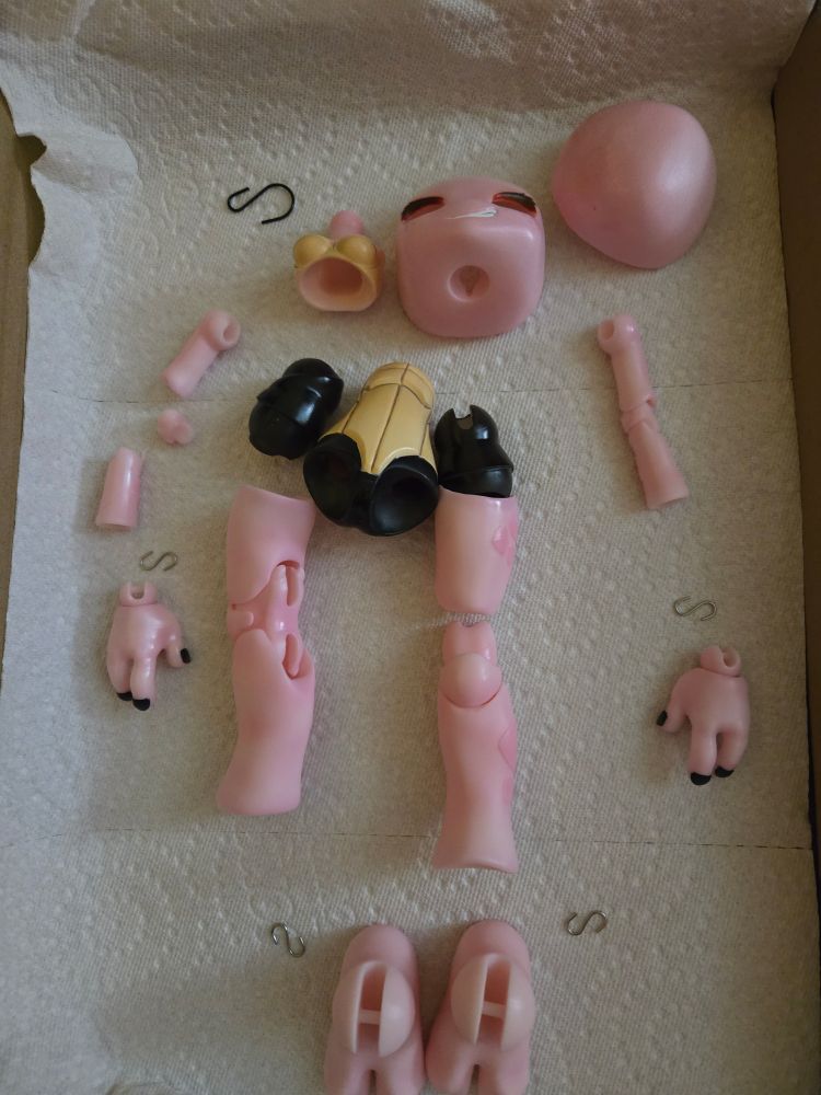 A pink/albino ball jointed turtle doll in various unassembled pieces  