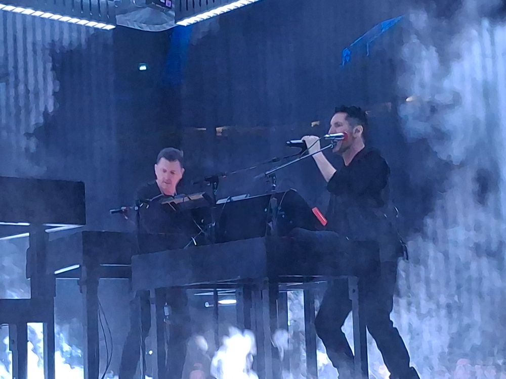 Trent Reznor signing and Atticus Ross playing Synthesizers.