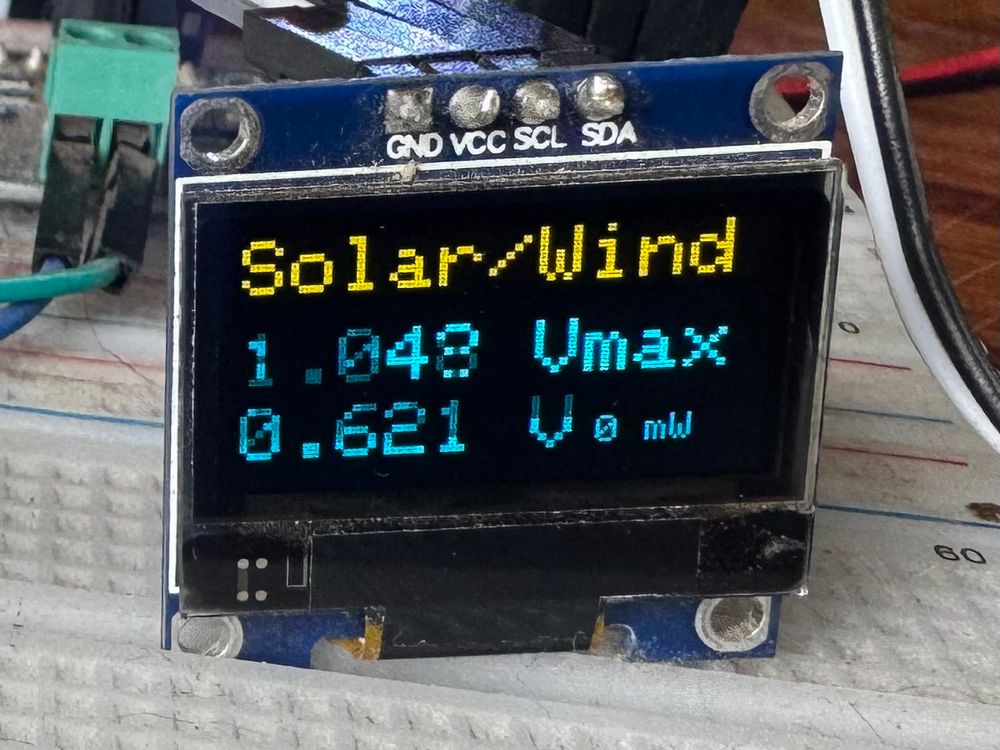 Small screen showing max volts and current volts from the one wind turbine at the top in previous video.