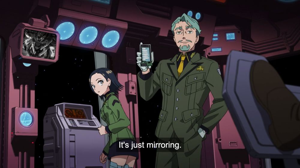 Challia shows his cellphone screen: “It's iust mirroring”. His phone has a green dongle attached to its bottom 