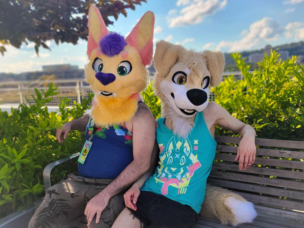 Custard and Honeydew sitting on a park bench