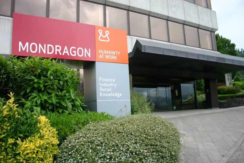 A Mondragon office with a sign out front that says "Humanity at Work"
