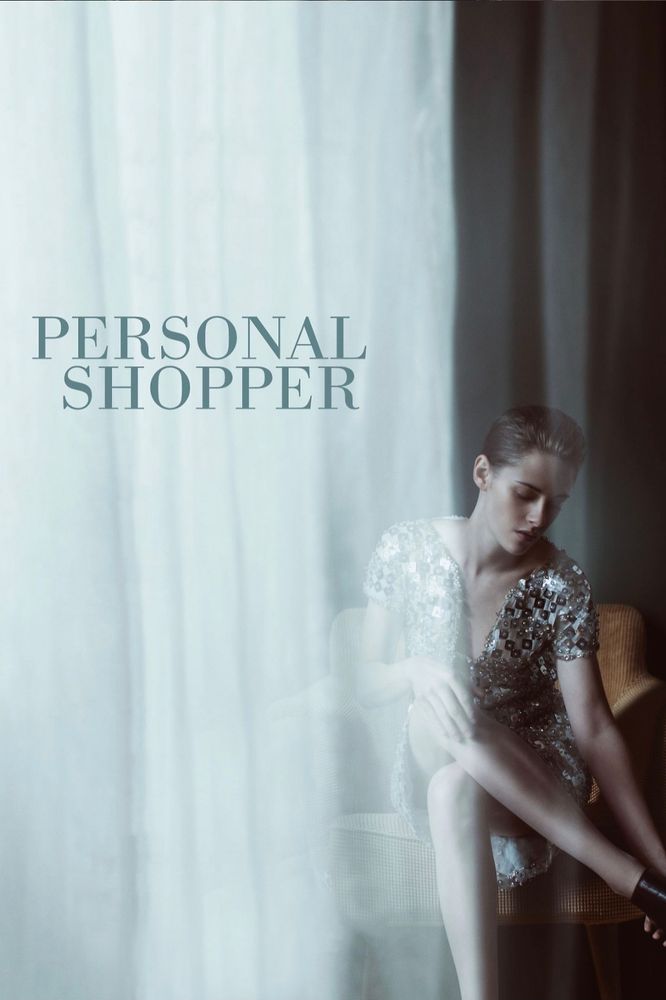 A white curtain covers two thirds of the image from the left. In the right side is a brunette woman sitting down in a silver dress. She is putting on a shoe.