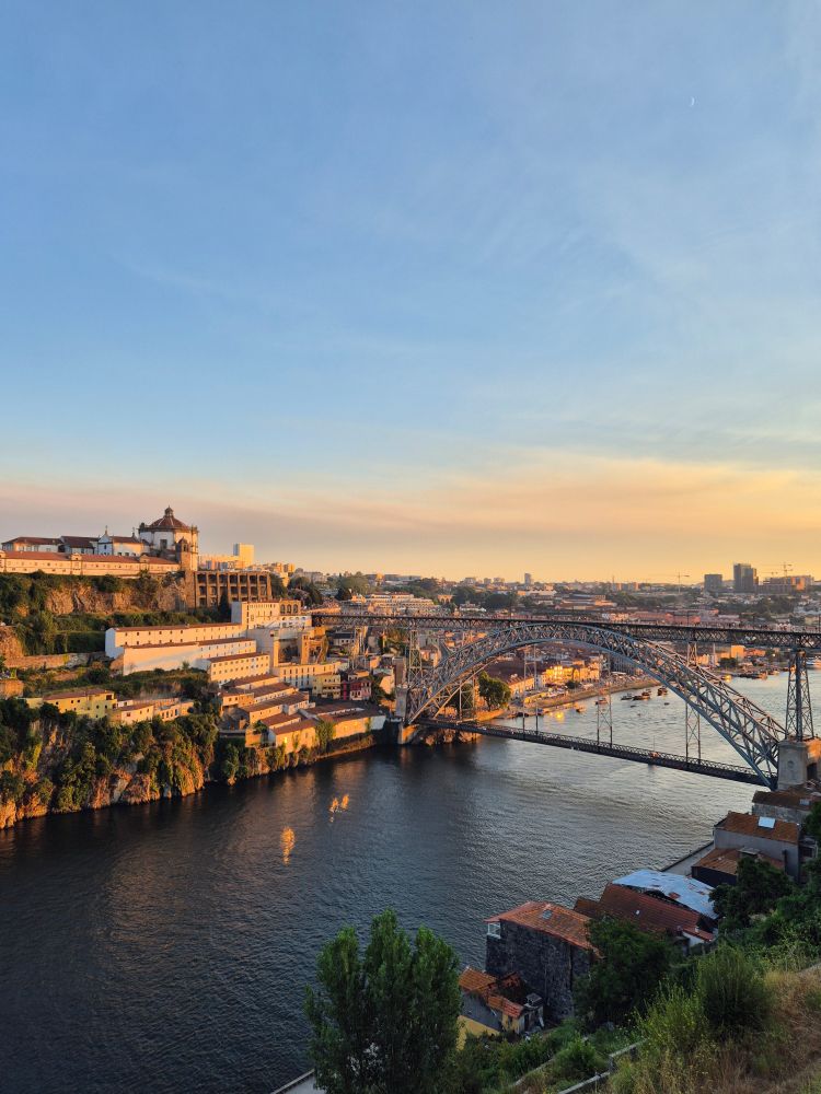 Sunset over a metal bridge (Dom Luis I bridge) and the river Douro