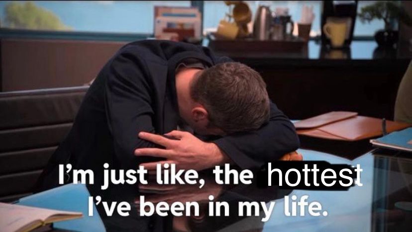 Tim Robinson laying his head down in the ITYSL skit where he chokes on a hotdog. Text is edited to say “I’m just like, the hottest I’ve been in my life.”