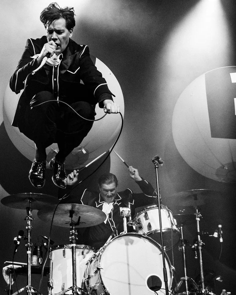 The Hives' lead singer Howlin Pelle Almqvist gets airborne during the band's performance at Dallas' House of Blues.