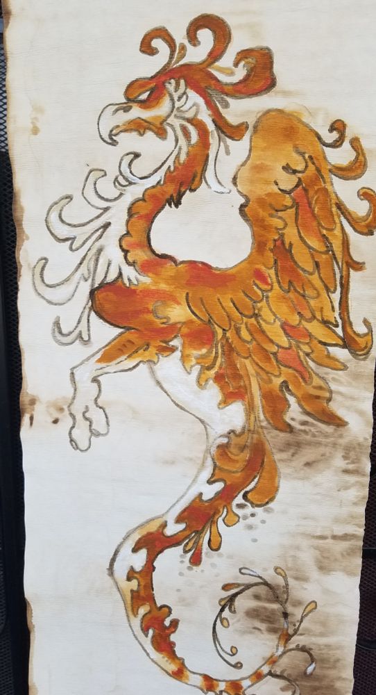 Gryphon like Phoenix bird with leafy feathers on stained parchment 