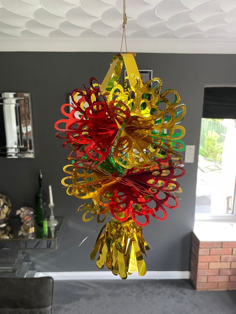 Very tacky 80s style Christmas chandelier made out of green, gold and red tinsel