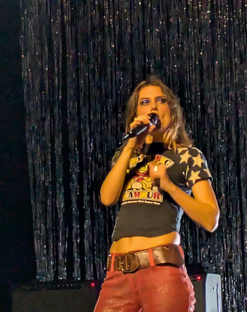 Ellie Rowsell, the singer of Wolf Alice, against a glittery backdrop 