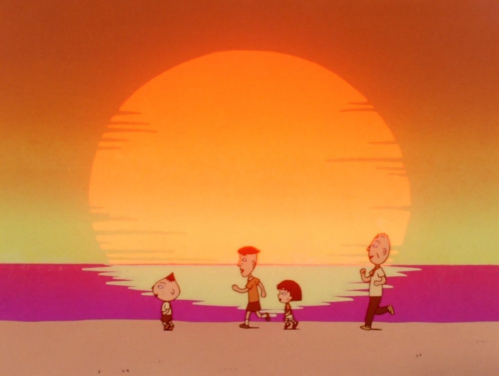 Nagasawa runs happily on the beach framed by the setting sun, as Fujiki, Maruko and Grandpa chase after him.