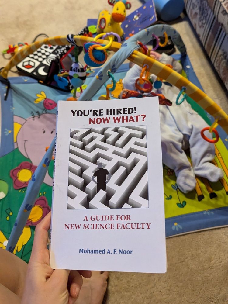 "you're hired, now what" book with baby playing in the background
