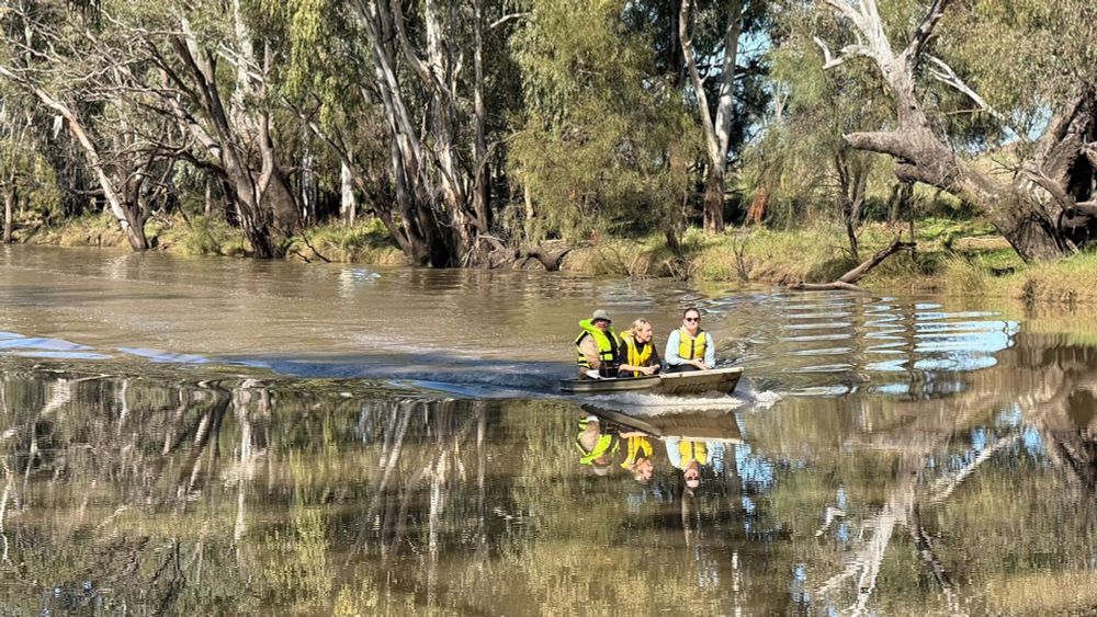 Scientists in a punt on a river 