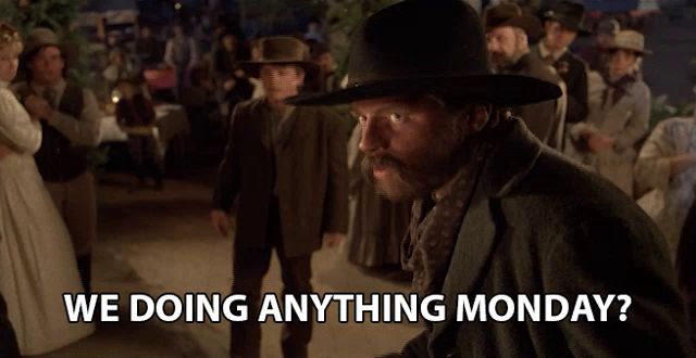 a man in a hat says we doing anything monday in front of a crowd