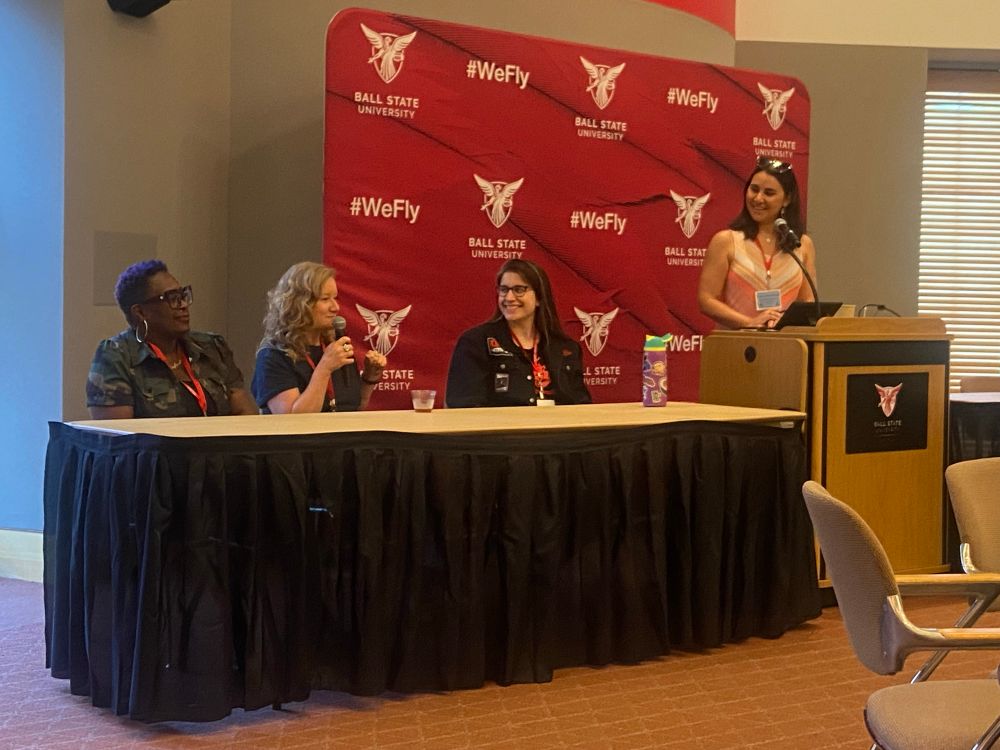 Three authors on a panel with a moderator 