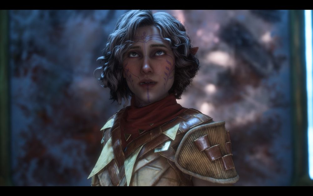A screenshot of a Dragon Age: The Veilguard player character.  She is an elf woman with light brown wavy, bobbed hair in leather armor with a neutral expression on her face.  Her face has purple, leaf-like markings on it.