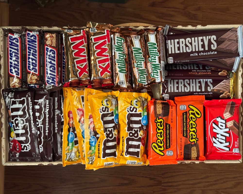 A tray with an assortment of full-sized candy bars ready to be distributed.